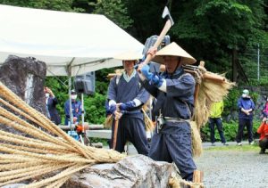 蔓に見立てた縄をおので切り開いて安全な登山を願う「蔓払い」の儀式＝南アルプス市芦安芦倉