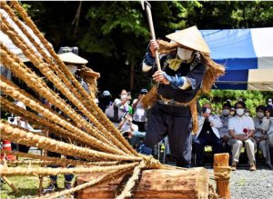 蔓に見立てた縄をおので切り開いて安全な登山を願う「蔓払い」の儀式＝南アルプス市芦安芦倉